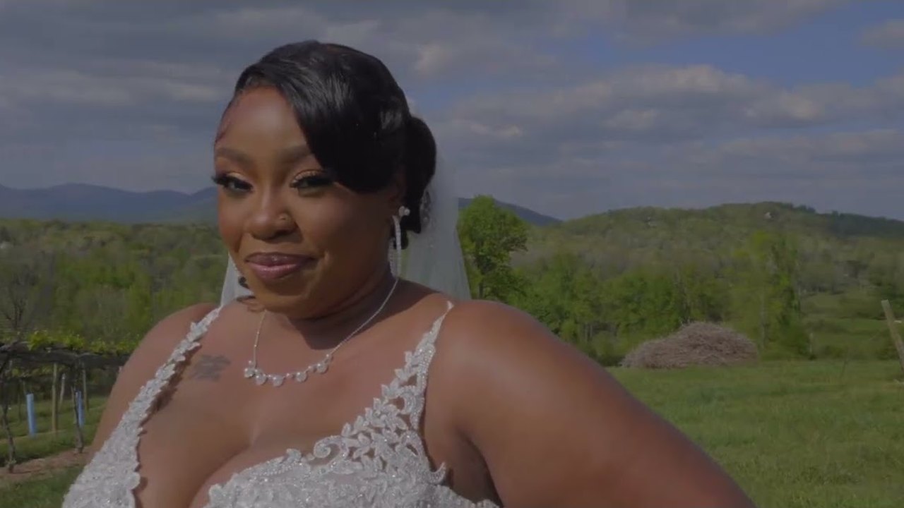 Bride smiling outdoors in a still from the Larry and La'ria wedding film